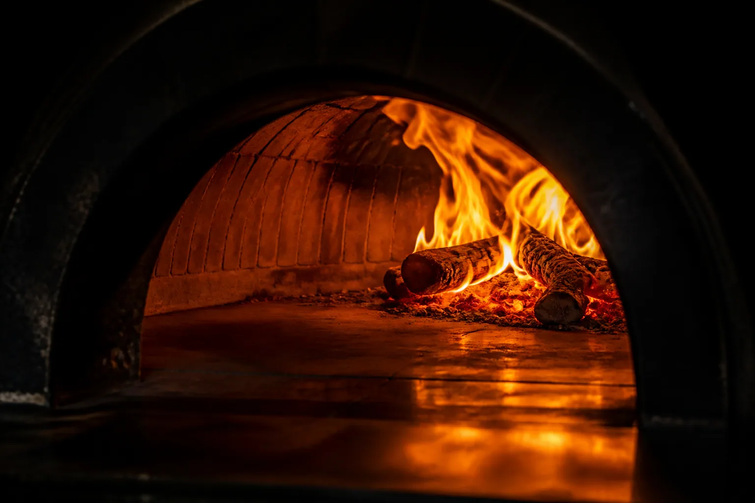 Flames curling inside the wood-fired oven at Stone & Crust